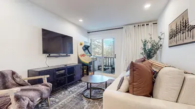 a living room with a couch and a tv at Timbers #12 townhouse in Mammoth Lakes