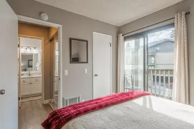 a bedroom with a bed and a large window at Crestview Bldg A #49 - Spacious 2 Bedroom, 2 Bathroom, Sleeps 7 - Close to Canyon Lodge and Village in Mammoth Lakes
