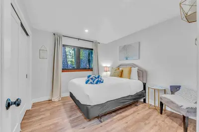 a white bedroom with a bed and a window at Bright Tahoe Home with Private Backyard Near Beach in Tahoe City