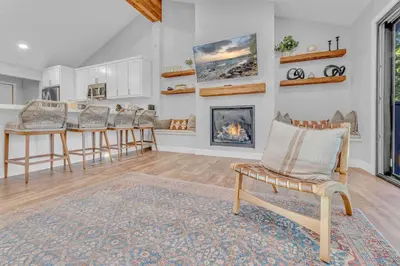 a living room with a table and chairs and a fireplace at Bright Tahoe Home with Private Backyard Near Beach in Tahoe City
