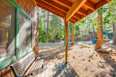 a porch with a bench on the side of a house at 1 Mi to Lake Tahoe Rustic Cabin with Boat Dock in Tahoma