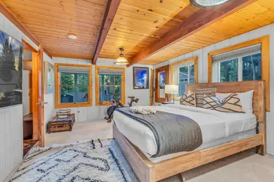 a bedroom with a large bed in a room with wooden ceilings at Modern Tahoe Retreat with Grill Walk to Beach in Homewood