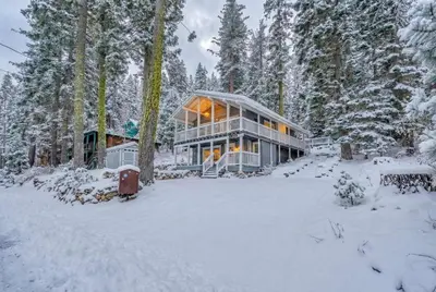 a large house in the snow in the woods at Modern Tahoe Retreat with Grill Walk to Beach in Homewood