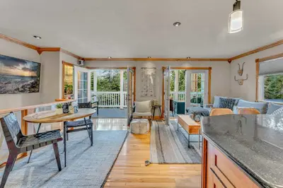 a living room with a table and a couch at Modern Tahoe Retreat with Grill Walk to Beach in Homewood