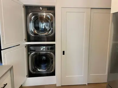 a kitchen with two washer and dryer in a room at The Sugar Pine Speakeasy in Homewood
