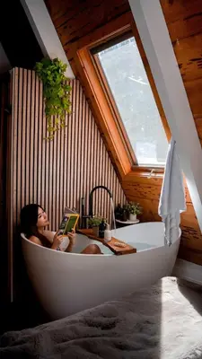 a woman sitting in a bath tub in a attic at The Sugar Pine Speakeasy in Homewood