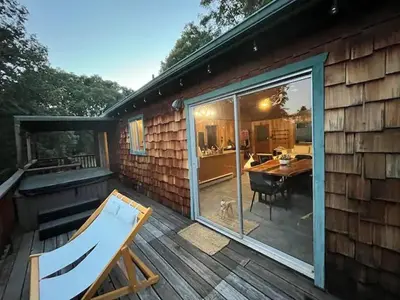 a large sliding glass door on a deck with a table at Mountain Dimension in Ponderosa Basin