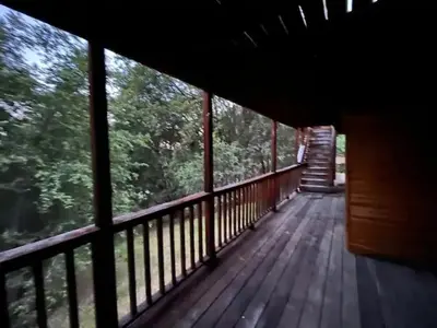 a wooden deck with a view of the woods at Mountain Dimension in Ponderosa Basin