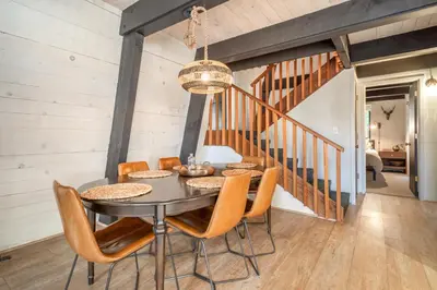 a dining room with a table and chairs at Mid Century Modern A-Frame Cabin at Northstar in Truckee