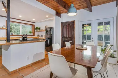 a kitchen and dining room with a wooden table and chairs at Sequoia TREE HOUSE light andbright in Three Rivers
