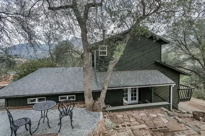 a house with a table and chairs in front of it at Sequoia TREE HOUSE light andbright in Three Rivers