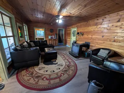 a living room with leather furniture and a fireplace at Baltyr Cabin in Miramonte