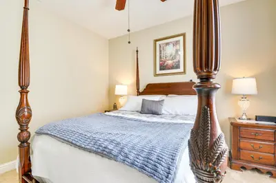 a bedroom with a large bed with a wooden post at 10 Mi to Yosemite Lake Atwater Retreat in Atwater