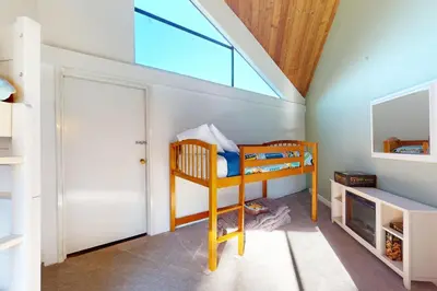 a room with a bunk bed and a window at Keys to Paradise in South Lake Tahoe