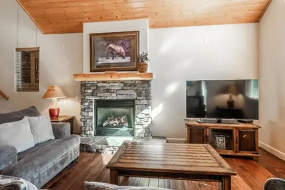 a living room with a couch and a fireplace at Mammoth Gateway Village #1 - Highly Updated Townhome - Walk To Village 3 Bed+Loft, Sleeps 10 in Mammoth Lakes