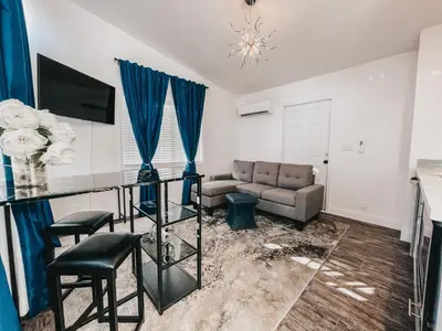 a living room with a couch and a table at Beautiful Courtyard Cottage Sapphire in Reno