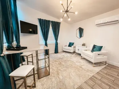 a large living room with a table and chairs at Beautiful Courtyard Cottage Emerald in Reno