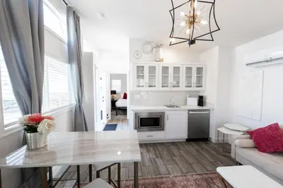 a kitchen and living room with a table and a couch at Elegant Courtyard Cottage Ruby in Reno