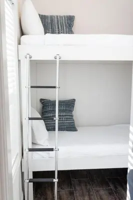 a couple of bunk beds with pillows on them at Beautiful Cottage on Historic Grounds in Reno