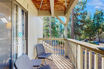 a porch with two chairs and a table and chairs at Inn at South Lake Tahoe in Kings Beach