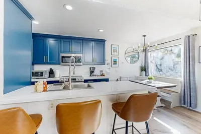 a kitchen with blue cabinets and white counter tops at Inn at South Lake Tahoe in Kings Beach