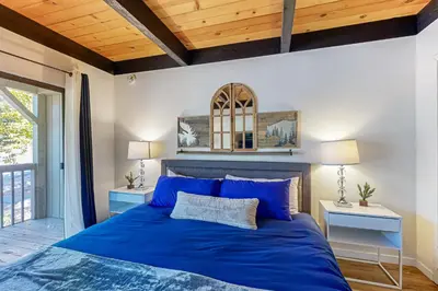 a bedroom with a blue bed and two night stands at Inn at South Lake Tahoe in Kings Beach