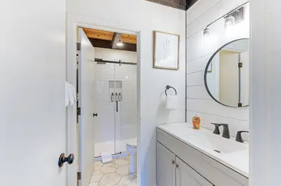 a white bathroom with a sink and a shower at Inn at South Lake Tahoe in Kings Beach