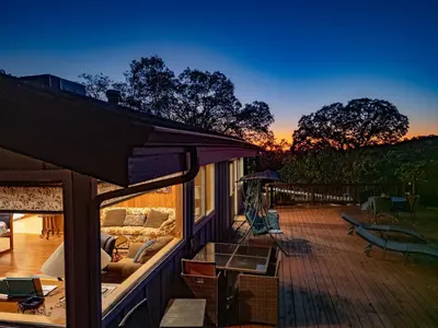 a screened in porch with a couch on a deck at Yosemite Mountain Top - Treetop Villa in Mariposa