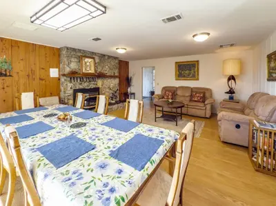 a dining room with a table and a living room at Yosemite Mountain Top Retreat Hilltop Manor Pool Spa in Mariposa