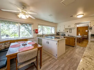 a kitchen and living room with a table and chairs at Yosemite Mountain Top Retreat Hilltop Manor Pool Spa in Mariposa