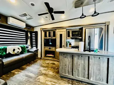 an rv living room with a bar and a couch at Puffy Panda RV-Hot Tub-Sleeps 2 in Ahwahnee