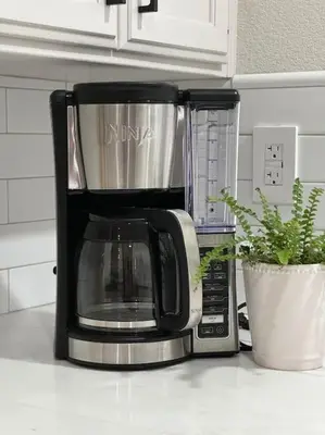 a coffee maker sitting on top of a microwave at Charming retreat in CA Valley in Fresno