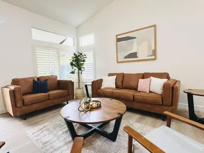 a living room with two couches and a coffee table at Charming retreat in CA Valley in Fresno