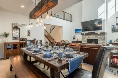 a dining room and living room with a table and chairs at Creekhouse 1374 in Mammoth Lakes