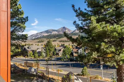 a view of a street with trees and mountains at Creekhouse 1374 in Mammoth Lakes