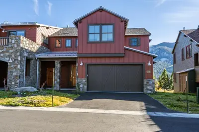 a red house with a garage at Creekhouse 1374 in Mammoth Lakes