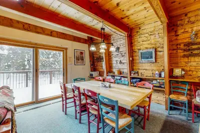 a dining room with a wooden table and chairs at The Calder Cabin in Soda Springs