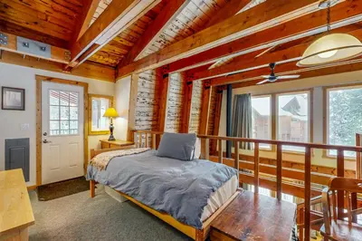 a bedroom with a bed and a balcony at The Calder Cabin in Soda Springs