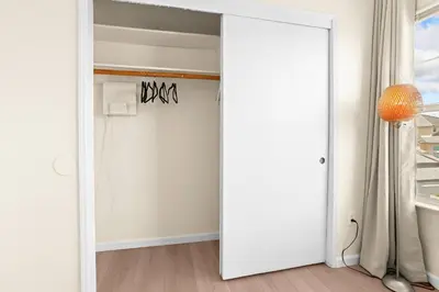 an open white door in a room with a window at Remodeled 3B2B Bright House with a King Suite in Sacramento