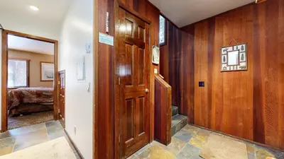 a hallway with wooden walls and a door and a bedroom at Winterset #33 condo in Mammoth Lakes