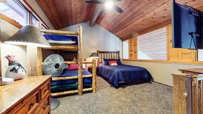 a bedroom with two bunk beds and a fan at Winterset #33 condo in Mammoth Lakes