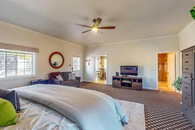a bedroom with a bed and a ceiling fan at Morgan Hill Couples Gem Villa in the Vineyards in Morgan Hill