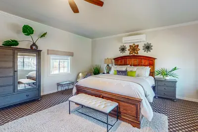 a bedroom with a large bed with a wooden headboard at Morgan Hill Couples Gem Villa in the Vineyards in Morgan Hill