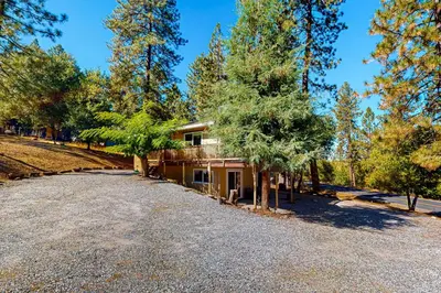 a house with a gravel driveway in front of it at Green Abode in Groveland