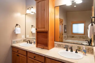 a bathroom with two sinks and a large mirror at Hillside Mountain Creek Haven home in Truckee