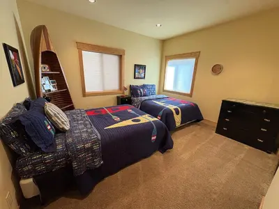 a bedroom with two beds and a dresser at Hillside Mountain Creek Haven home in Truckee