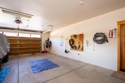 a large room with a garage with a sliding door at Hillside Mountain Creek Haven home in Truckee