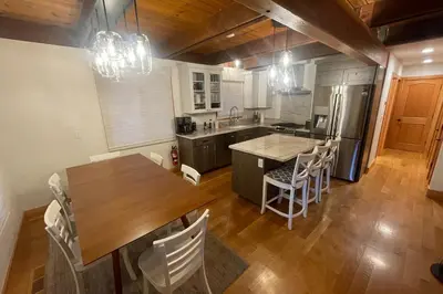 a kitchen with a wooden table and a table and chairs at Tahoe West Shore Escape in Tahoe City