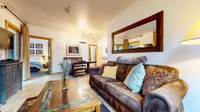 a living room with a couch and a mirror at Juniper Springs Lodge #246 condo in Mammoth Lakes