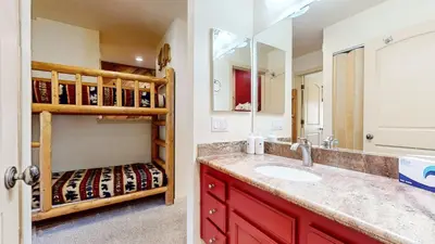 a bathroom with a sink and a bunk bed at Snowcreek II #279 condo in Mammoth Lakes